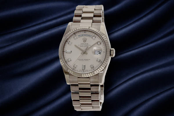 Close-up of a Rolex President bracelet showing semi-circular three-link design in precious metal